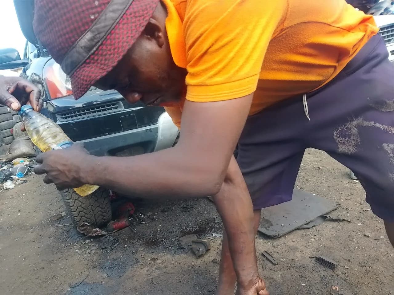 ONYEBEST mechanic servicing a customer's vehicle at Ladipo Volvo Plaza, Mushin, Lagos